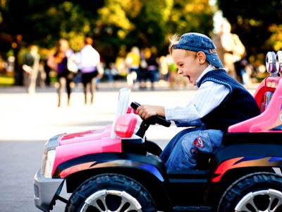 Noone can stop me now! Child looks excited driving little toy outlander